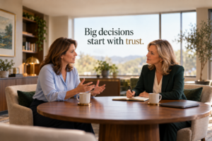 Two professional women discuss a business decision at a table, one speaking while the other listens with a pen and notebook. Text reads, “Big decisions start with trust.”